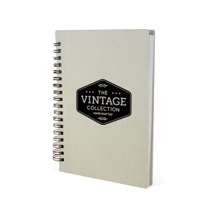Spiral bound notebook made from ABS plastic and wheat straw with an antibacterial coating. Includes 70 sheets of lined white paper.