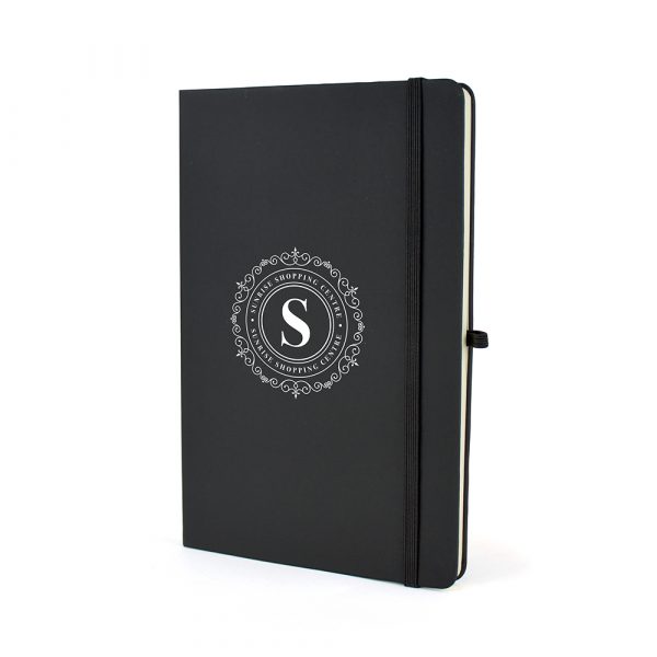 A5 mole notebook with antibacterial coating for extra safety! Includes 80 lined pages, pen loop, bookmark, elastic closure and rear pocket. Available in black only.