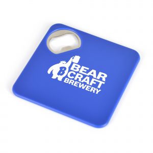 Square plastic coaster with a built-in bottle opener in one corner and a foam grip backing.