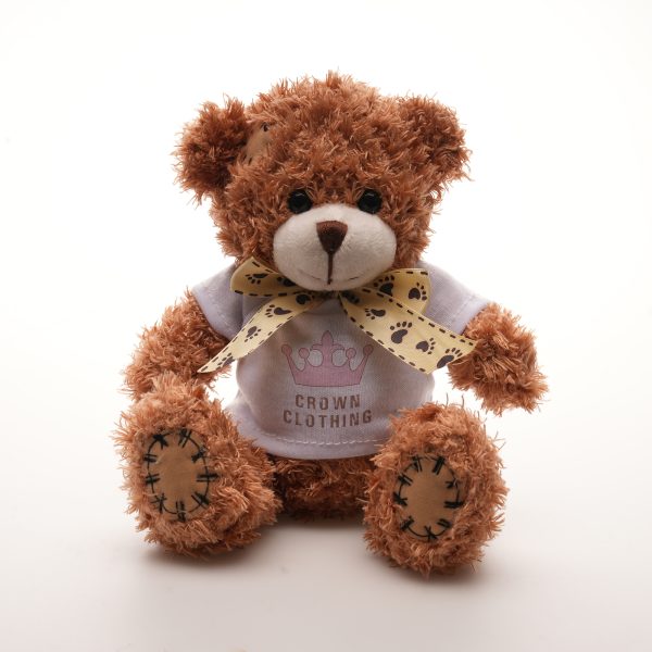 Crafted with polyester skin fabric and charming ribbon neck tie for added elegance, this 18cm teddy bear comes with cotton filler, embroidered thread nose and mouth and PP plastic eyes, adding a delightful tactile element with white t-shirt for branding.