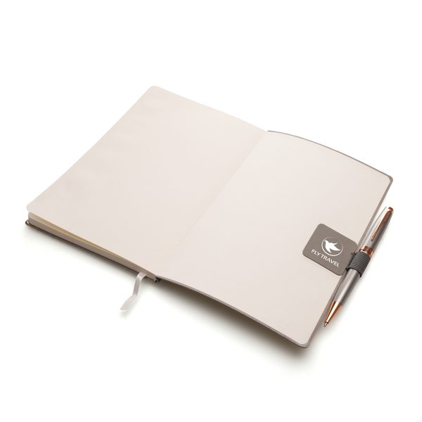Elastic pen loop mounted to a PU leather patch with a self-adhesive backing to attach to the back of your notebook. Pantone matching available at an additional cost