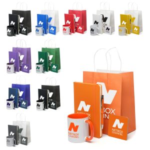 Create a professional and welcoming touch for your meetings or conferences with this ready-to-go set, designed to be waiting on the table for each attendee. Each gift set includes a branded medium sized paper bag with twist paper handles, containing an A5 notebook with a matching pen for notes and ideas, a square cork coaster, and a classic Cambridge ceramic mug printed in vibrant full colour. To complete the experience, a biscuit and a hot chocolate sachet are also included, offering a comforting refreshment break. With every item customised with your logo, this set ensures your corporate identity is carried through seamlessly, leaving a lasting impression on your guests. Enquire today!